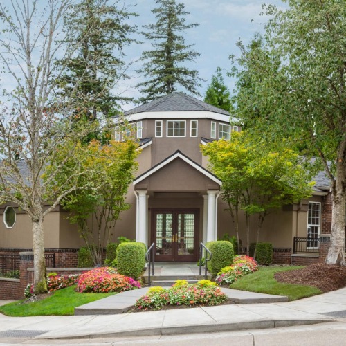 Welcome Home a house with trees and bushes around it