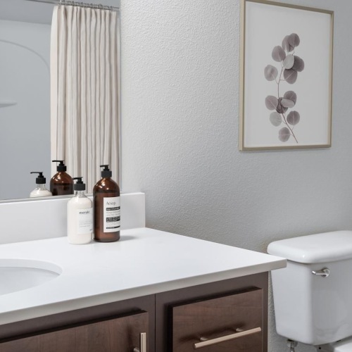 Spacious bathrooms with everything you need a bathroom with a sink toilet and mirror