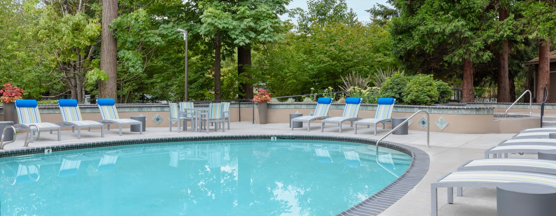 a pool with chairs around it